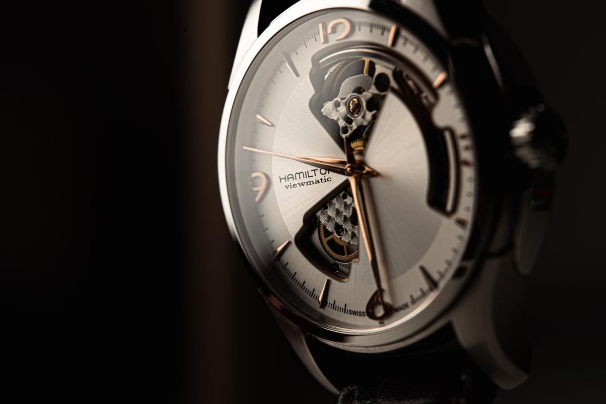 Close-up of an automatic watch with an open dial showing the movement